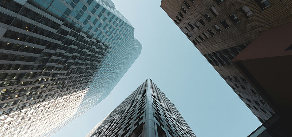 photo of the tops of skyscrapers taken from the ground looking directly up, sbauer in the news